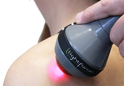 Lightforce deep-tissue laser delivering therapeutic light to a patient's shoulder